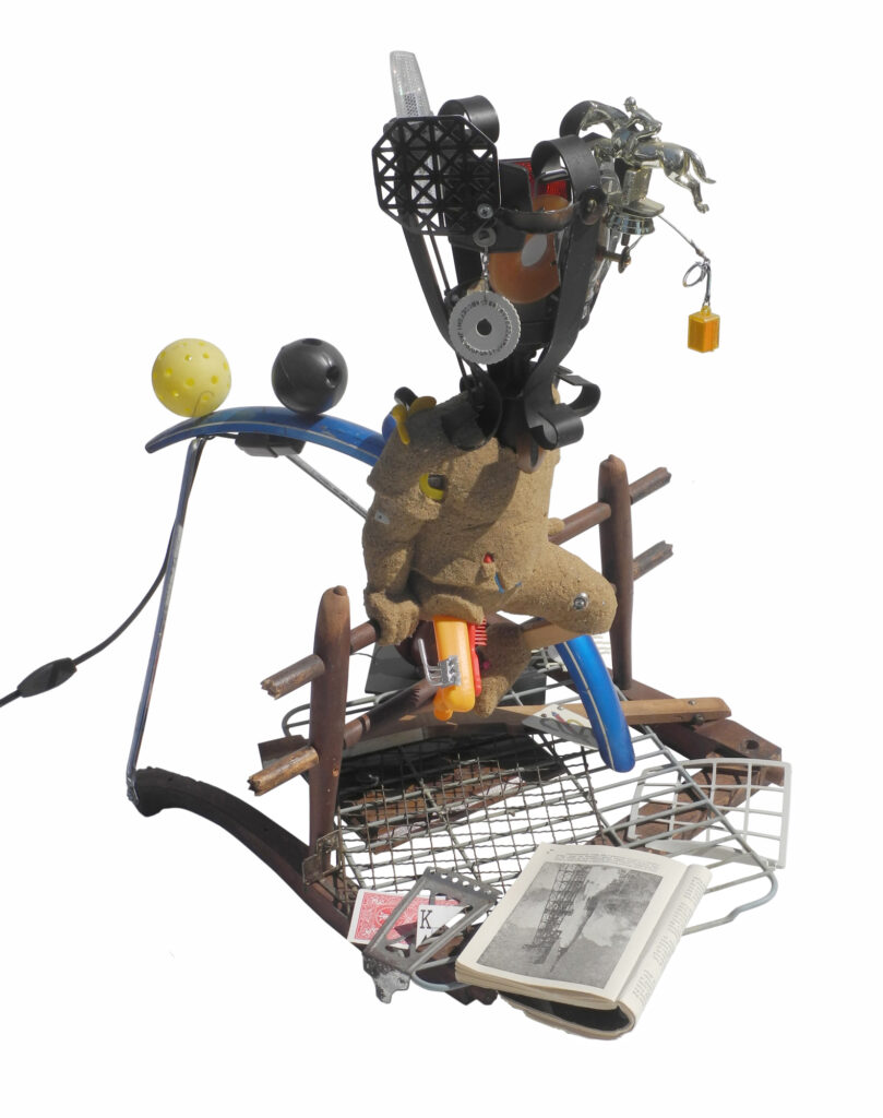 Street Urchin #36 2011, sand, acrylic medium, objects, electric light, 27 x 26 x 21 inches